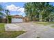 Traditional home with a well-kept lawn and a two-car garage at 7020 Oakview Cir, Tampa, FL 33634