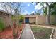 Inviting home entrance with walkway, attractive landscaping with mulch, and a blue front door at 7020 Oakview Cir, Tampa, FL 33634