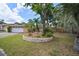 Charming single-story home with a meticulously maintained front yard with mature landscaping at 7020 Oakview Cir, Tampa, FL 33634