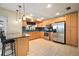 Bright kitchen featuring light wooden cabinets, stainless steel appliances and a breakfast bar at 7020 Oakview Cir, Tampa, FL 33634