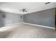 Open living room with tiled floors, neutral walls and a ceiling fan at 7020 Oakview Cir, Tampa, FL 33634