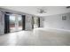 Bright and open living room with neutral walls, tiled flooring, and access to the backyard at 7020 Oakview Cir, Tampa, FL 33634
