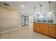 Open concept living area with tile flooring, an island, and pendant lighting at 7020 Oakview Cir, Tampa, FL 33634