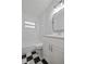 Renovated bathroom with stylish black and white tile floor, white vanity, and a shower-tub combo at 7139 Adare Dr, New Port Richey, FL 34653
