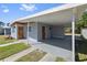 Spacious covered carport featuring a painted floor, and an entry door to the home at 7139 Adare Dr, New Port Richey, FL 34653