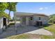 Covered carport offering shade, with convenient access to a shed and the home's exterior at 7139 Adare Dr, New Port Richey, FL 34653