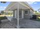 Screened in carport offering shade, with convenient access to a shed and the home's exterior at 7139 Adare Dr, New Port Richey, FL 34653