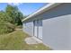 Home exterior with sliding glass doors leading to the backyard on a sunny day at 7139 Adare Dr, New Port Richey, FL 34653