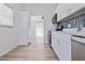 Bright and airy kitchen featuring white cabinets, stainless steel appliances, and hardwood floors at 7139 Adare Dr, New Port Richey, FL 34653