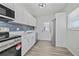 Updated kitchen with stainless steel appliances, white cabinets, and a stylish backsplash at 7139 Adare Dr, New Port Richey, FL 34653