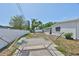 Lush backyard featuring a cozy hammock, outdoor seating and a stone fire pit for outdoor enjoyment and relaxation at 7491 Cedar Ne St, St Petersburg, FL 33702