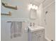 Bright white bathroom featuring open shelving and a shower at 7491 Cedar Ne St, St Petersburg, FL 33702
