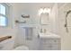 Bright bathroom featuring a shower, vanity, and tiled walls at 7491 Cedar Ne St, St Petersburg, FL 33702