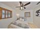 This bedroom has a ceiling fan, hardwood floors, and natural light coming through shuttered windows at 7491 Cedar Ne St, St Petersburg, FL 33702