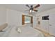 This bedroom has a ceiling fan, hardwood floors, and ensuite bathroom at 7491 Cedar Ne St, St Petersburg, FL 33702