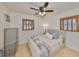 This bedroom has a ceiling fan, hardwood floors, and natural light coming through shuttered windows at 7491 Cedar Ne St, St Petersburg, FL 33702