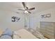 Light and airy bedroom featuring a comfortable bed, closet space, a ceiling fan, and neutral decor for a serene atmosphere at 7491 Cedar Ne St, St Petersburg, FL 33702