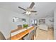 Bright dining room featuring hardwood floors, ceiling fan, and a view into the living room at 7491 Cedar Ne St, St Petersburg, FL 33702