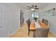 Bright dining room featuring hardwood floors, ceiling fan, and a view into the kitchen at 7491 Cedar Ne St, St Petersburg, FL 33702