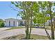Charming single-story home featuring a circular driveway, white exterior, and landscaped front yard at 7491 Cedar Ne St, St Petersburg, FL 33702