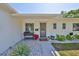 Inviting front entrance with decorative landscaping and a freshly painted exterior, and neutral colors at 7491 Cedar Ne St, St Petersburg, FL 33702