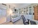 Bright home office with white walls, built-in shelving, and a comfortable sitting area that could function as a den at 7491 Cedar Ne St, St Petersburg, FL 33702