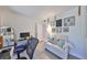 Bright office space featuring a white loveseat, modern desk setup, and tastefully decorated walls at 7491 Cedar Ne St, St Petersburg, FL 33702