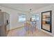Cozy breakfast nook features a stylish bar table with seating, adjacent to the kitchen with stainless steel appliances at 7491 Cedar Ne St, St Petersburg, FL 33702