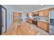 Well-lit kitchen features stainless appliances, ample cabinet space, tile flooring, and a convenient island for meal prep at 7491 Cedar Ne St, St Petersburg, FL 33702