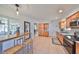 Spacious kitchen features stainless appliances, tile floors, and a cozy breakfast bar with seating, bathed in natural light at 7491 Cedar Ne St, St Petersburg, FL 33702