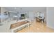 Open-concept living room featuring hardwood floors, a large sectional sofa, and dining area at 7491 Cedar Ne St, St Petersburg, FL 33702