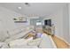 Spacious living room with a large sectional sofa, hardwood floors, a television and decor at 7491 Cedar Ne St, St Petersburg, FL 33702