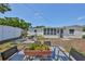 Backyard patio with a stone fire pit and outdoor seating at 7491 Cedar Ne St, St Petersburg, FL 33702