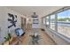 Cozy sun room with tiled floors, lots of windows and a ceiling fan at 7491 Cedar Ne St, St Petersburg, FL 33702