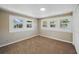 Bedroom with three windows offering natural light and neutral-colored walls and carpet at 8215 N 12Th St, Tampa, FL 33604