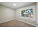 Cozy bedroom with carpet flooring, a bright window, and neutral wall color at 8215 N 12Th St, Tampa, FL 33604