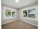 Bright bedroom with large windows providing abundant natural light and neutral colored carpet at 8215 N 12Th St, Tampa, FL 33604