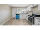 Well-lit kitchen boasts white cabinets, new appliances, and a convenient layout at 8215 N 12Th St, Tampa, FL 33604