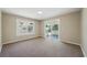 Living Room with large sliding doors, and neutral walls and carpet at 8215 N 12Th St, Tampa, FL 33604