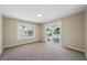 Living Room with sliding glass doors to the porch, window, and neutral walls and carpet at 8215 N 12Th St, Tampa, FL 33604