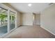 Living Room with large sliding doors, and neutral walls and carpet at 8215 N 12Th St, Tampa, FL 33604