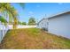 Backyard with newly planted sod and a partial view of the detached home at 8409 Lantana Dr, Seminole, FL 33777