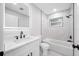 Bright bathroom features marble tile, a bathtub, and a modern, illuminated mirror at 8409 Lantana Dr, Seminole, FL 33777