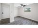 Bright bedroom with new gray flooring, a modern ceiling fan, and a window view at 8409 Lantana Dr, Seminole, FL 33777