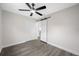 Bright bedroom featuring a modern ceiling fan, sliding door, and gray floors at 8409 Lantana Dr, Seminole, FL 33777
