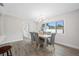 Cozy dining room featuring modern decor, a stylish chandelier, and hardwood floors at 8409 Lantana Dr, Seminole, FL 33777