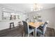 Bright dining area featuring a modern chandelier and direct access to the updated kitchen with marble countertops at 8409 Lantana Dr, Seminole, FL 33777