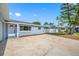 Side view of a cozy home with a spacious driveway and manicured landscaping at 8409 Lantana Dr, Seminole, FL 33777
