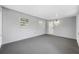 Enclosed Florida room with gray floors, white walls and multiple windows at 8409 Lantana Dr, Seminole, FL 33777
