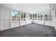 Large screened-in lanai features gray floors and views of the backyard pool at 8409 Lantana Dr, Seminole, FL 33777